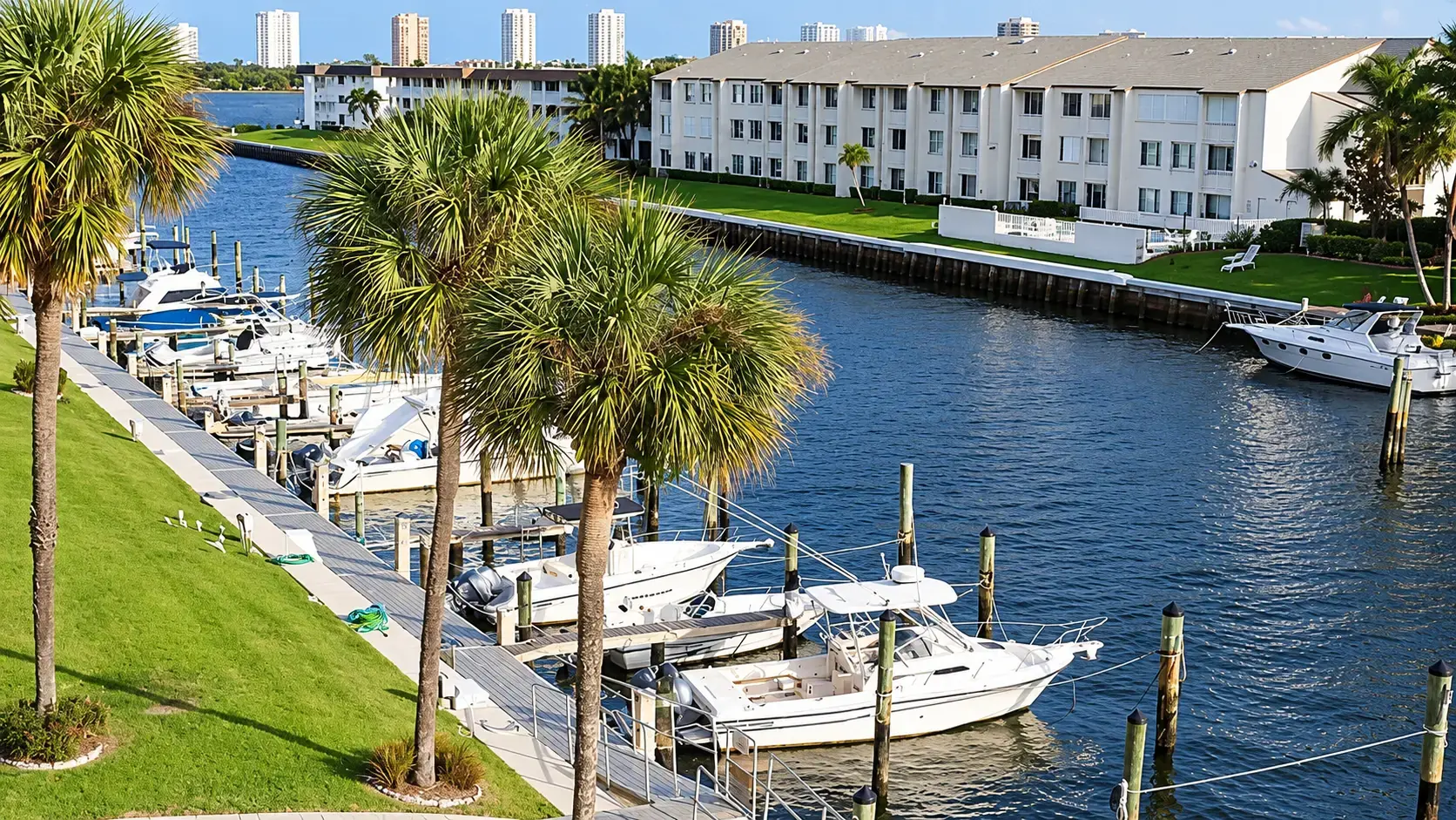 Palm trees and boats along a waterfront marina in northern Palm Beach County